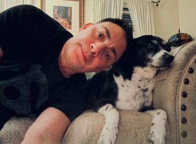 Man and dog relaxing on a couch.
