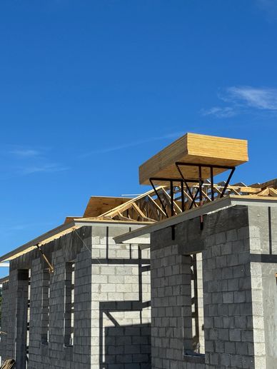 Wooden structure being built above a concrete building.