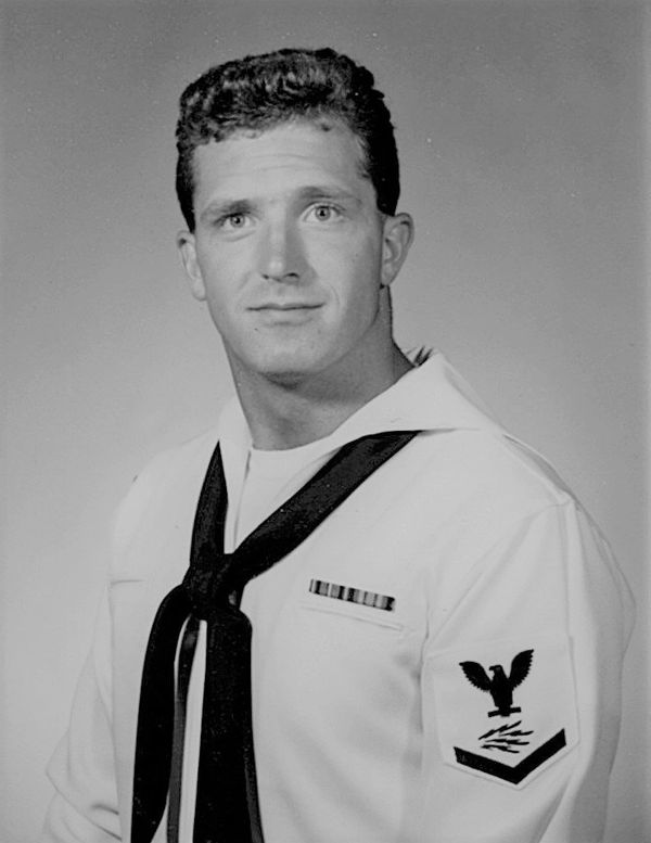 Black and white portrait of a young navy sailor in uniform.