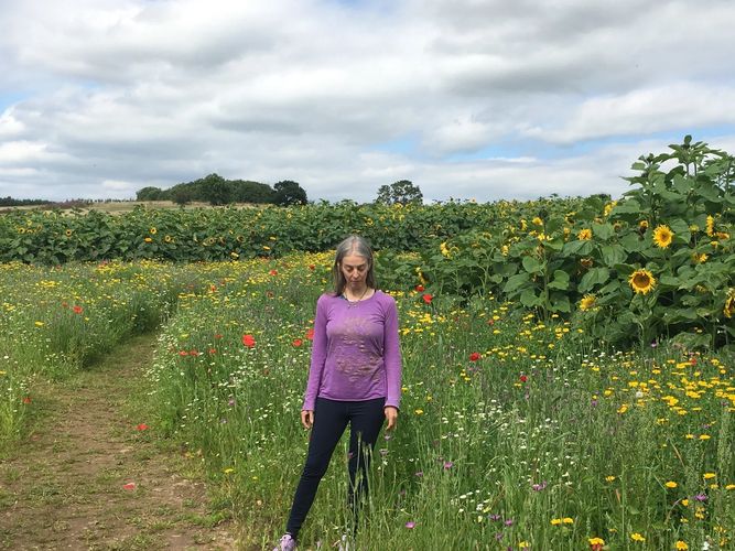 Karen in a field of poppies, sunflowers and wildflowers