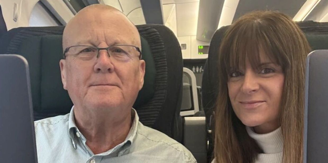 Man and woman smiling on an airplane.
