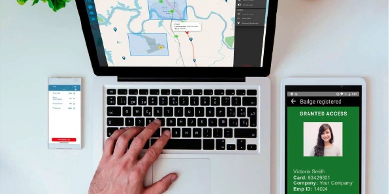 Person using laptop and mobile devices for access control and mapping.