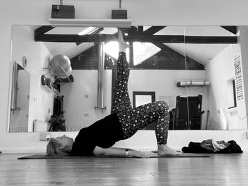 Pilates with Andrea demonstrating a bridge in studio