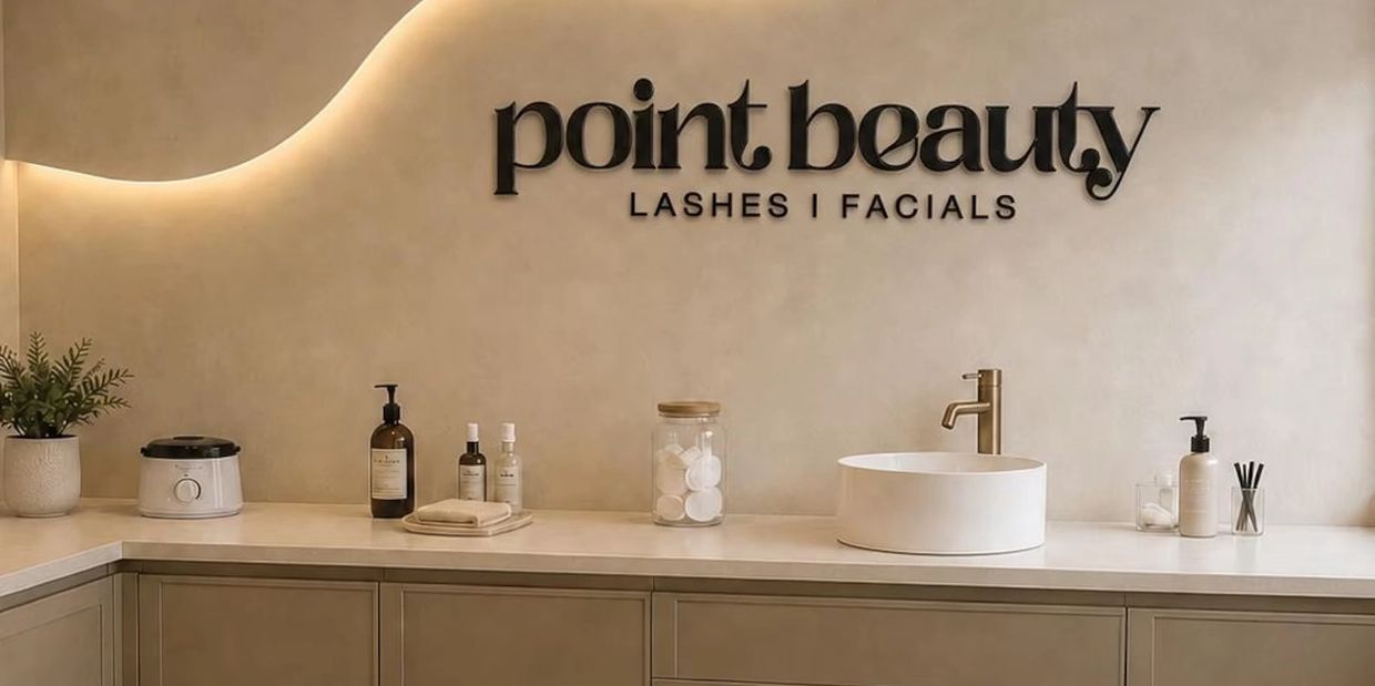 Beauty salon counter with various skincare products and sink.