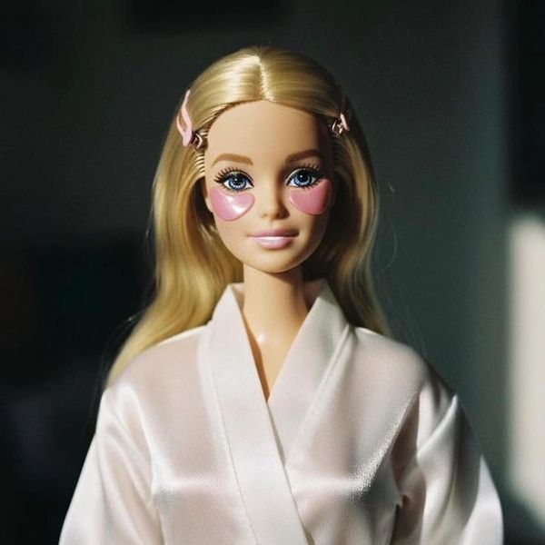 Barbie doll with pink heart-shaped eye patches and blonde hair.