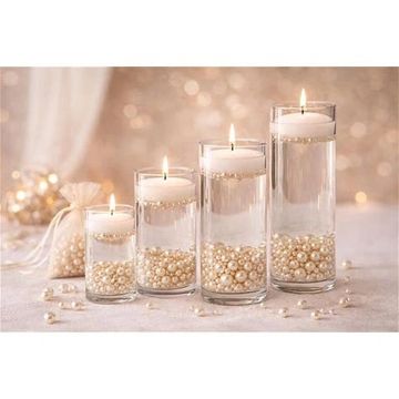 Elegant floating candles in glass vases filled with pearls.