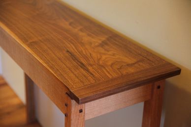 White Oak and Walnut Hall Table with floating top and bread board ends.