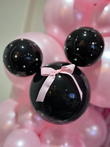 Black and pink Mickey Mouse-shaped balloon with pearls and a pink bow.