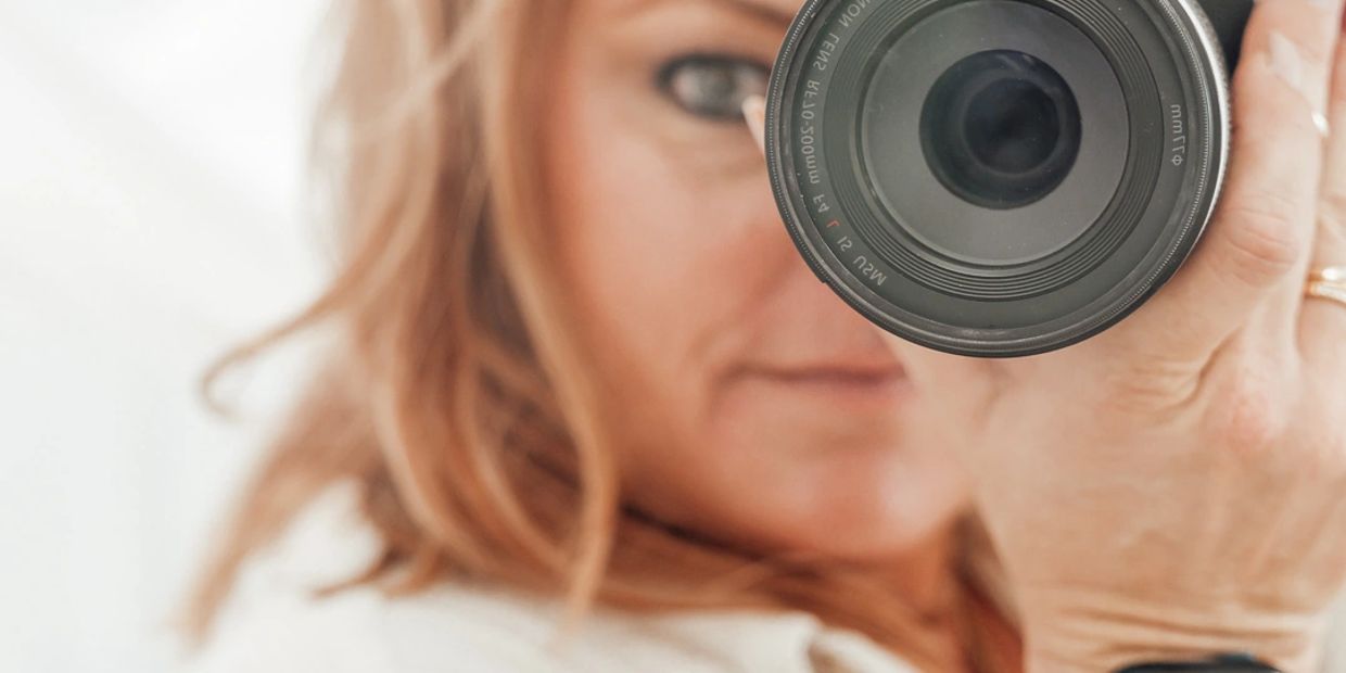 Person taking a close-up photo with a camera lens.