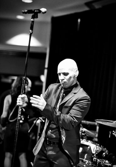 Man performing with microphone on stage.