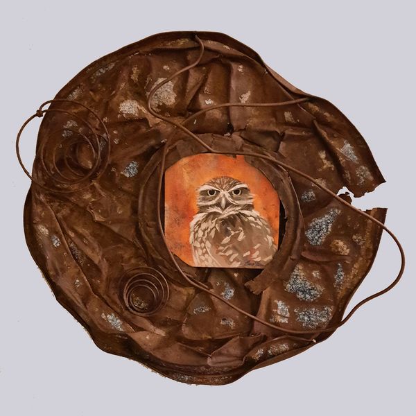 Circular art piece with an owl painting and leather-like textures.