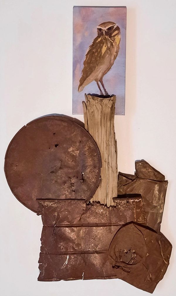 Rustic metal sculpture with owl painting.