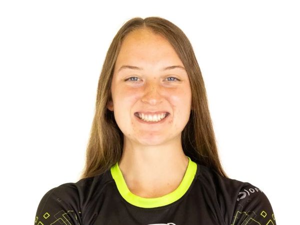 Smiling rugby player wearing a Life University Rugby jersey with arms crossed.