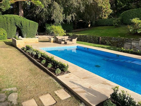 A luxury garden with a swimming pool created by Stevie Fairless in Corbridge