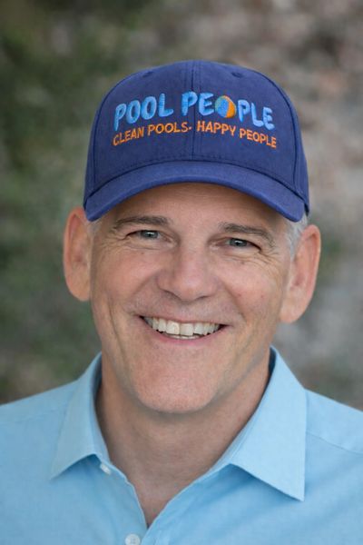 Smiling man wearing a blue cap with 'POOL PEOPLE' and a light blue shirt.