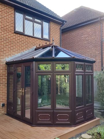 a brown uPVC double glazed conservastory with a glass conservatory roof