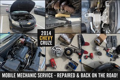 Mobile mechanic repairing a 2014 Chevy Cruze with tools and engine work shown.