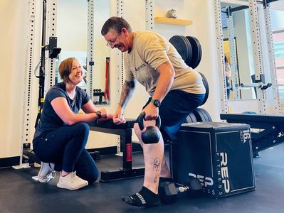 Physical therapist guiding strength and mobility training during one-on-one rehabilitation session