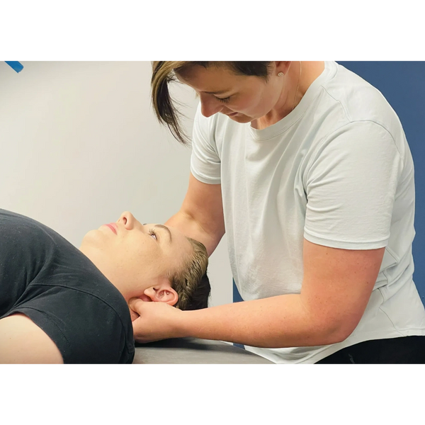 Physical therapist performing manual therapy on patient’s neck at NeuroRx Physical Therapy