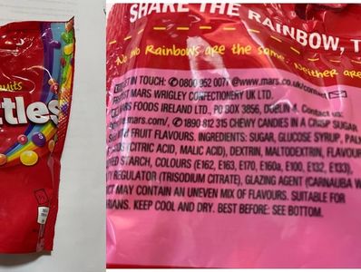 Close-up of candy package with colorful branding and ingredient details.