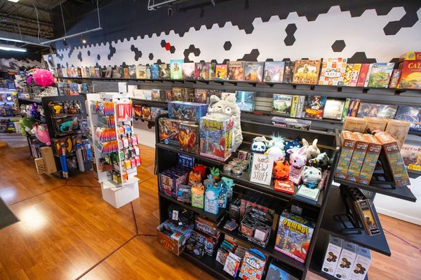 Critical Hit Games retail shelves covered in board games.