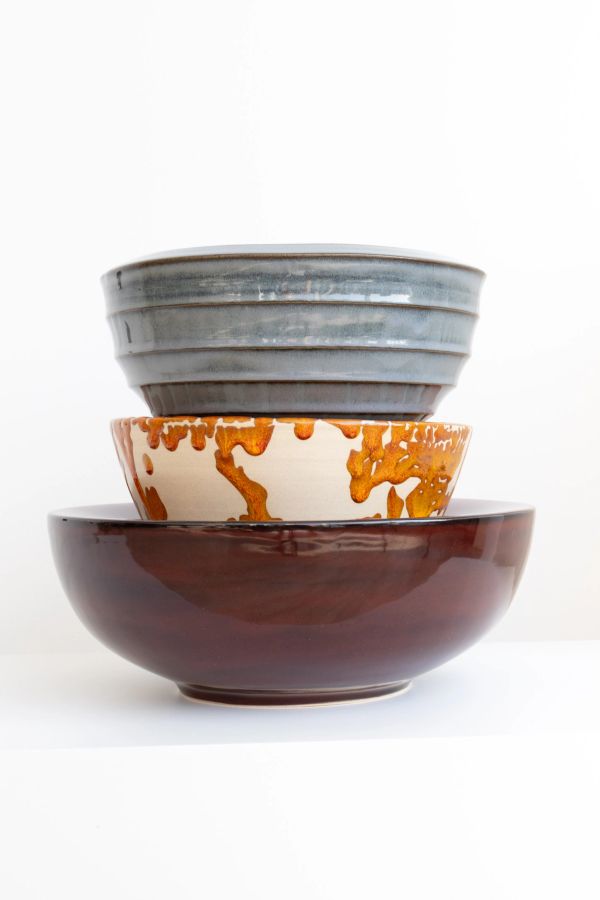 Stack of three ceramic bowls with different colors and textures.