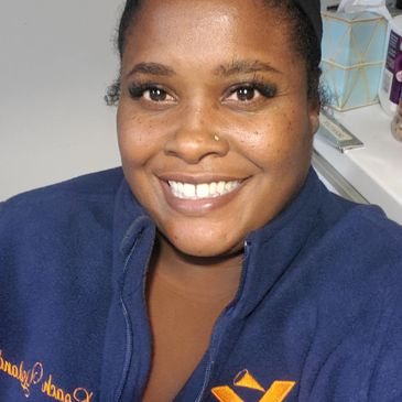 Smiling woman wearing a navy blue fleece jacket.