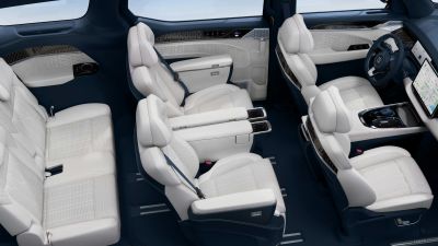 Luxurious white leather interior of a modern vehicle with spacious seating.
