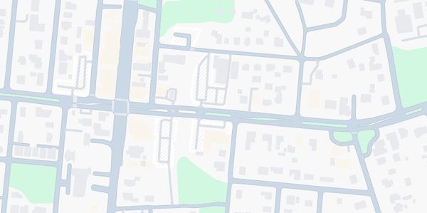 A simple city map showing streets and green areas.