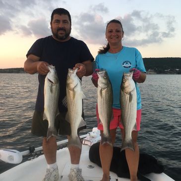 Two People Holding Fish In Hand