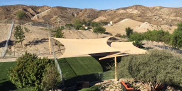 Sail shades over artificial turf at The Dog Psychology Center
