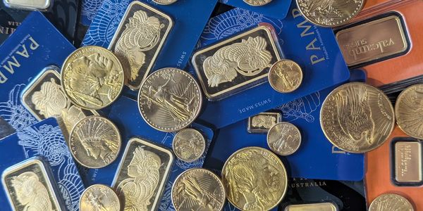 Collection of gold coins and bars with certificates.
@ Rome Gold Buyers & Loan