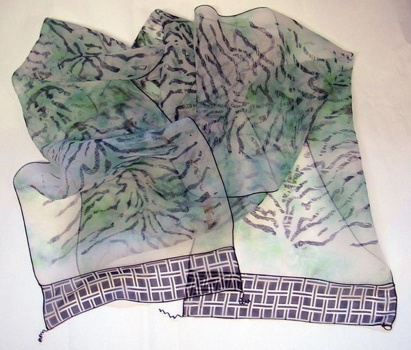 A sheer silk scarf with tiger stripe patterns in navy blue