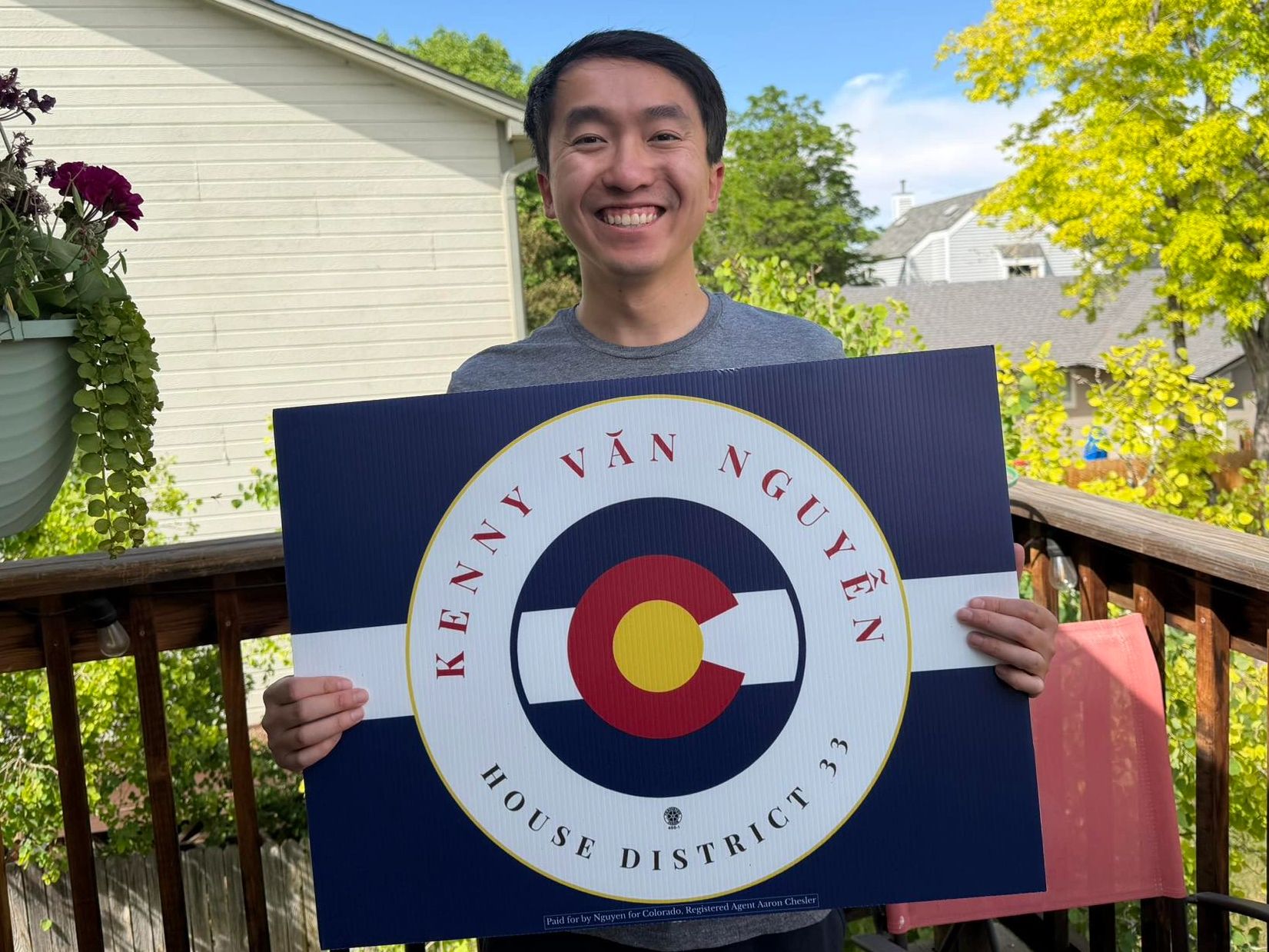 Person holding a campaign sign for Kenny Ván Nguyễn for House District 33.