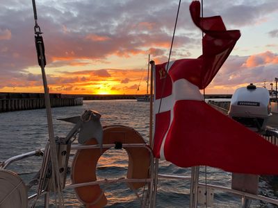 Sunset at sea. Sailboat in the wind