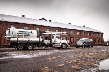 Two work trucks parked outside a building