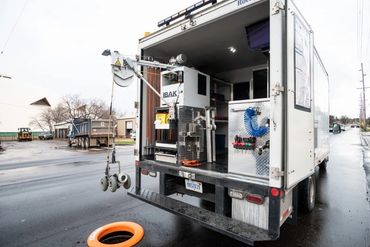 Work truck inspecting a manhole