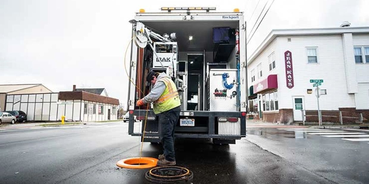 Worker inspecting a manhole