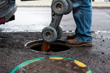 Worker inspecting a manhole