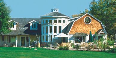 A large house with unique architecture and a green lawn.