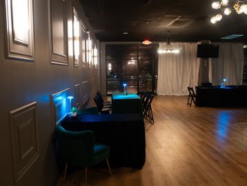 Modern event space with tables, chairs, and soft lighting.
