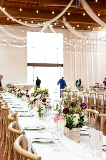 Elegant wedding reception setup with floral centerpieces.