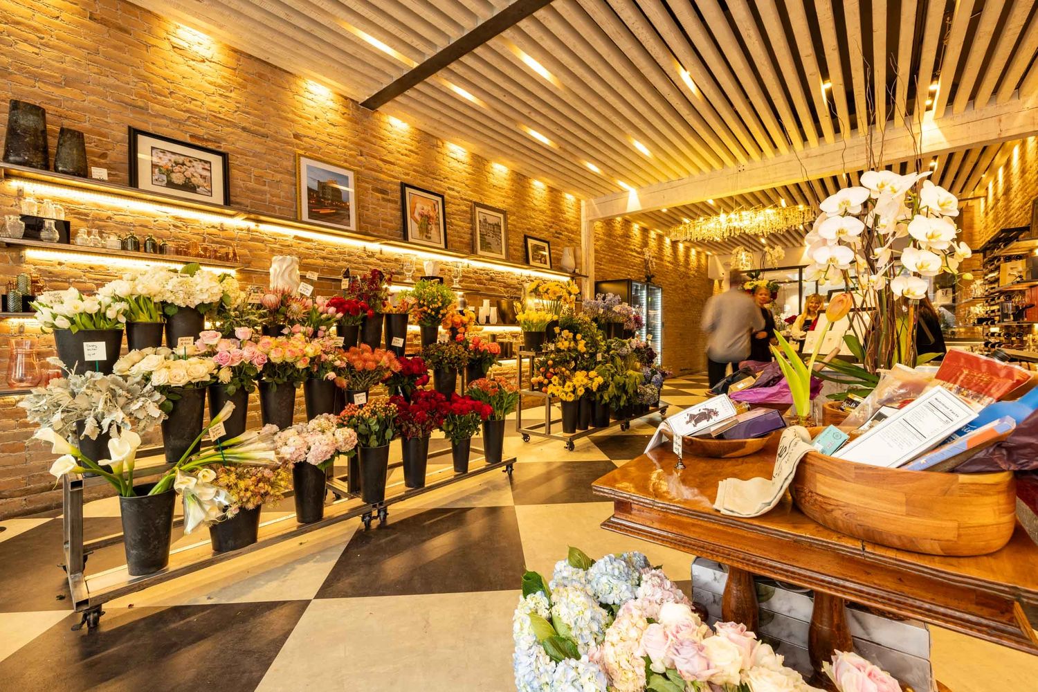 Bright and elegant flower shop with diverse blooms and warm lighting.