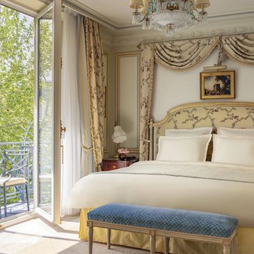 Elegant bedroom with classic decor and balcony view.