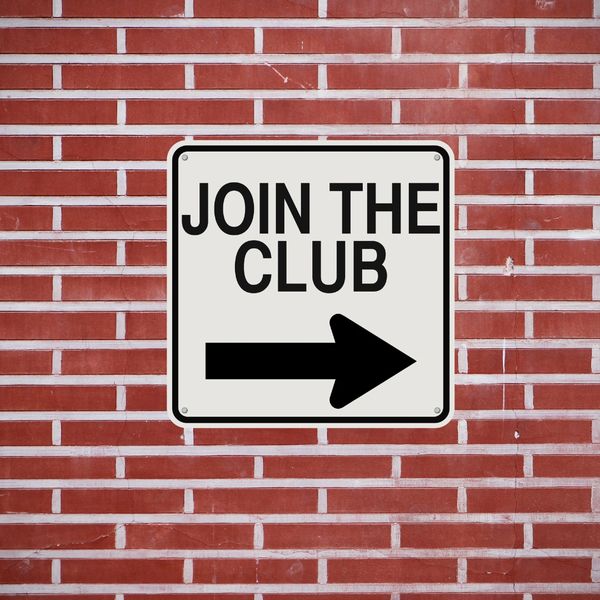 Sign on a brick wall reads 'JOIN THE CLUB' with a right arrow.