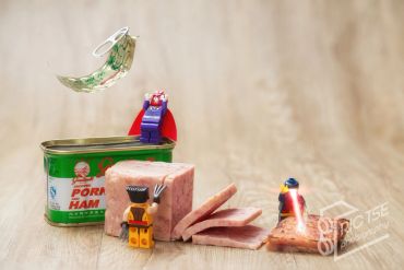 LEGO figures interacting with sliced ham and an open can.