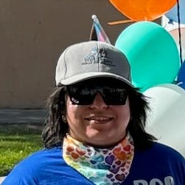 Team photo with a van at Albuquerque Pride Parade in June 2024. 
