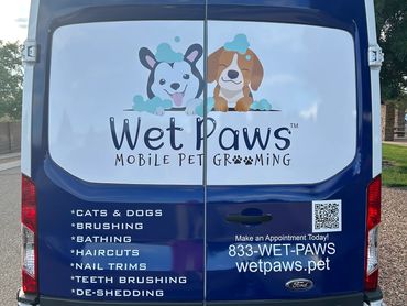 Image of the back of a Wet Paws mobile grooming van.