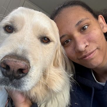 Close-up selfie of a person with a golden retriever.