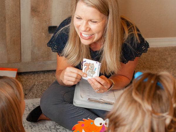 Photo of speech therapist working with two children. 